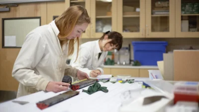 Scientists sub-sampling split sediment cores